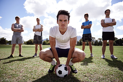 Buy stock photo Portrait of a group of serious soccer players standing on a playing field