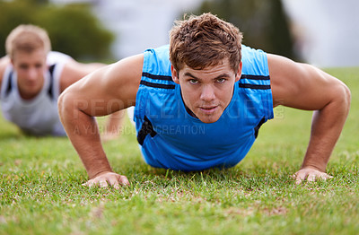 Buy stock photo Closeup shot of a young man doing push-ups