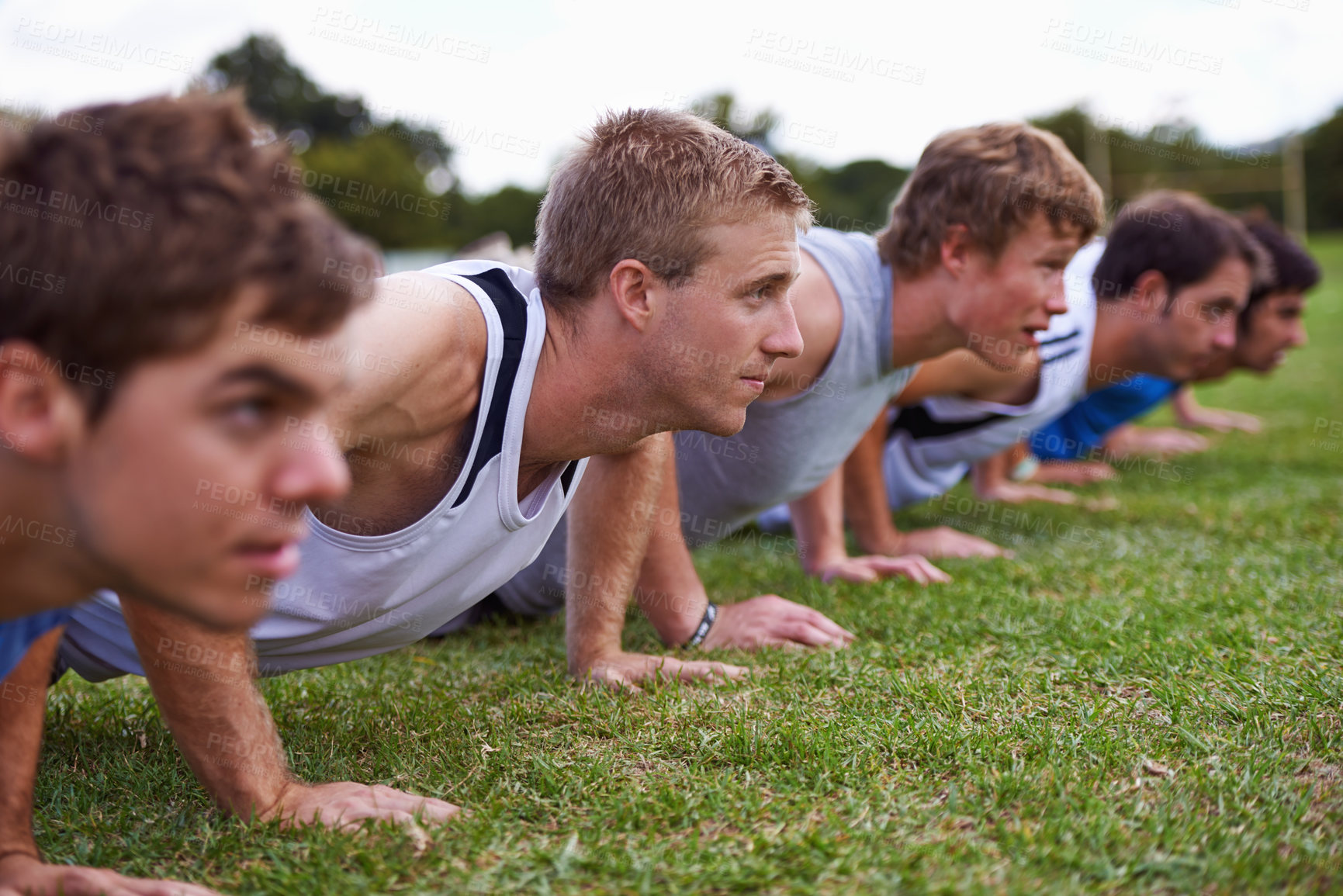 Buy stock photo Group, men and field for push up with exercise, training and health with friends for sport, challenge or wellness. People, athlete and teamwork with fitness, workout and together on grass for muscle
