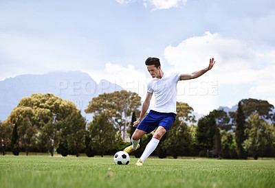 Buy stock photo Man, soccer player and shooting with ball on field with power, speed and aim at target in training for club. Person, football and sport with kick exercise and workout for wellness, fitness and game