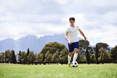Buy stock photo Man, soccer player and dribble with ball on field for moving, speed or skills in low angle at club on training ground. Person, football and sport with exercise, steps and workout for fitness in game