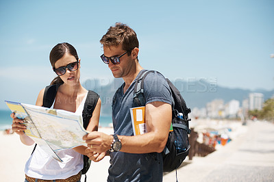 Buy stock photo Couple, map and reading with direction at beach, summer and ideas to check path on vacation. Woman, man and chart for location, landmark and travel with search on sidewalk, sea and nature in Italy