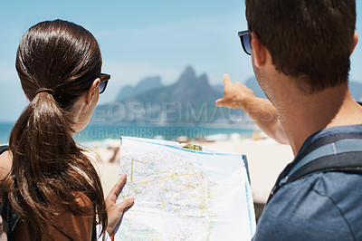 Buy stock photo Couple, map and pointing in summer by beach, mountains or smile to check direction for help on vacation. Woman, man and chart at location, landmark or reading with guide on holiday by ocean in Italy