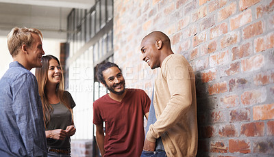 Buy stock photo Talking, laughing and college friends or students in a hallway for a happy discussion. Group of diversity men and a woman at campus or university for a funny conversation about education career