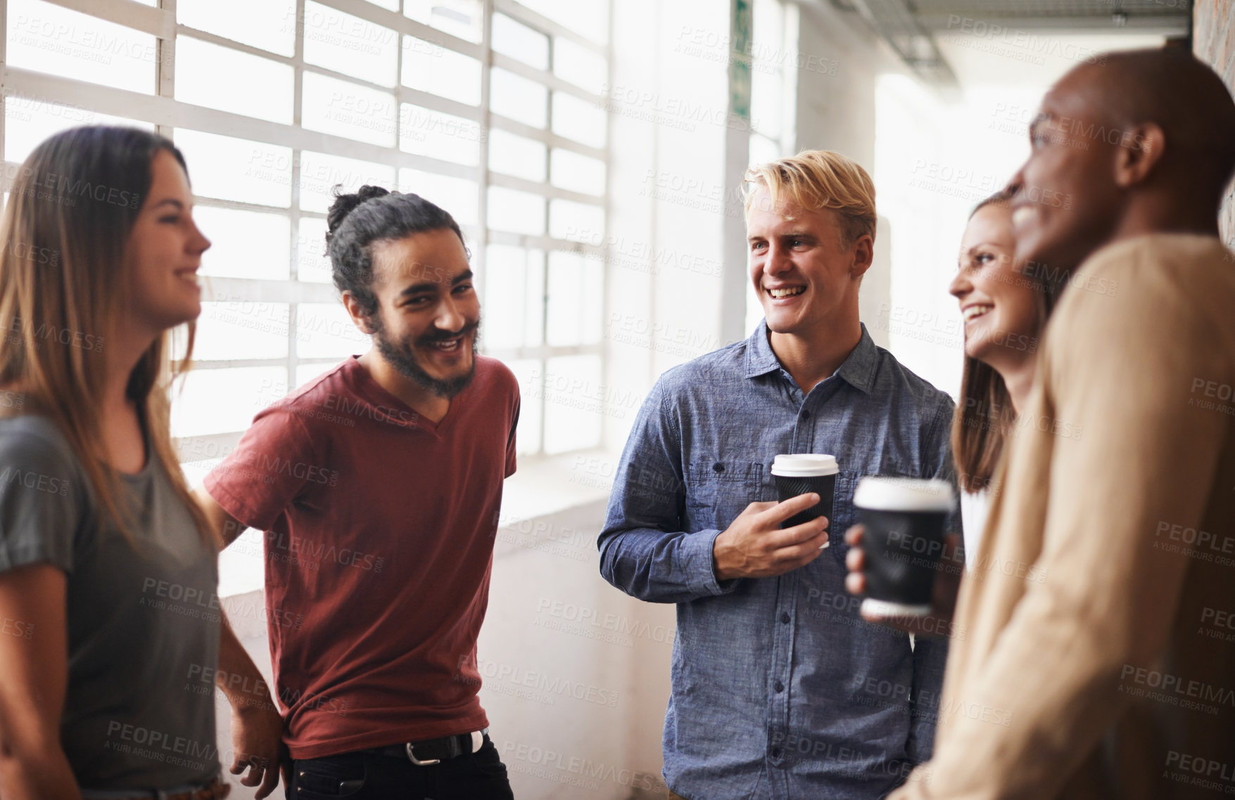 Buy stock photo Talking, group and friends in a hallway, students and conversation with happiness, bonding and joyful. Diversity, young people and men with women, communication and discussion in a lobby with a smile