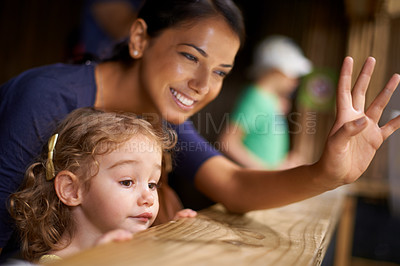 Buy stock photo Smile, mother and child at zoo for bonding, love and weekend fun looking at animals from stable. Mom, daughter and family at farm, nature park and cute for outing and holiday getaway with little girl