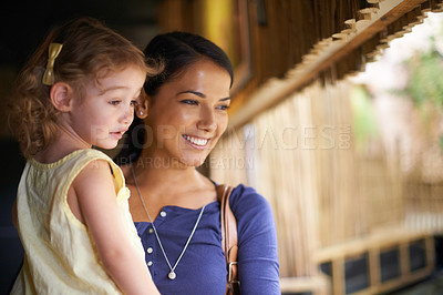Buy stock photo Cropped shot of a mother and daughter looking at a marine life attraction