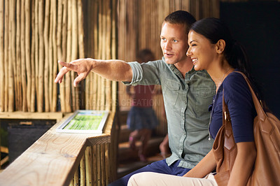 Buy stock photo Happy couple, pointing and date at aquarium with tourist for sightseeing, travel or tour at the zoo. Man showing woman adventure, spot or watching with smile to explore exhibit for guide or vision