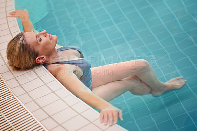 Buy stock photo Cropped shot of a mature woman relaxing in an indoor swimming pool