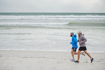 Buy stock photo Ocean waves, men and running on beach, sand and fitness for wellness and gym wear on coast together. Male athletes, jog and training for seaside, health and outdoor for sport and exercise in workout
