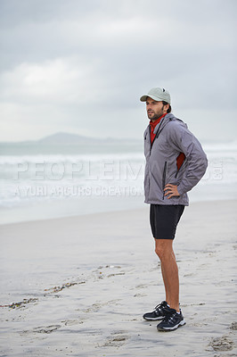 Buy stock photo Fitness, break and man thinking at a beach after training, running or winter morning cardio in nature. Workout, recovery and male runner at the sea for sports rest, breathing or body wellness routine
