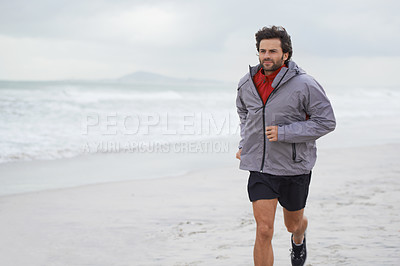 Buy stock photo Man, running and exercise at beach for fitness, health and wellness in morning. Athlete person, training and workout in sea with sky, sand and water for sports or motivation or hobby in ocean