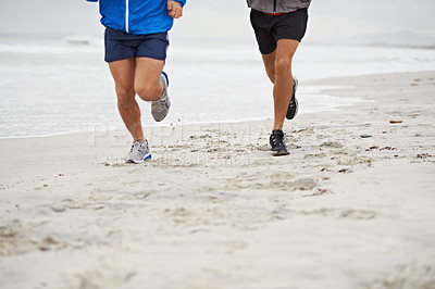 Buy stock photo Beach, legs or friends running for exercise, wellness or training outdoor in nature to workout for body health. Ocean, shoes or people together for fitness, cardio or jog for sport with energy at sea