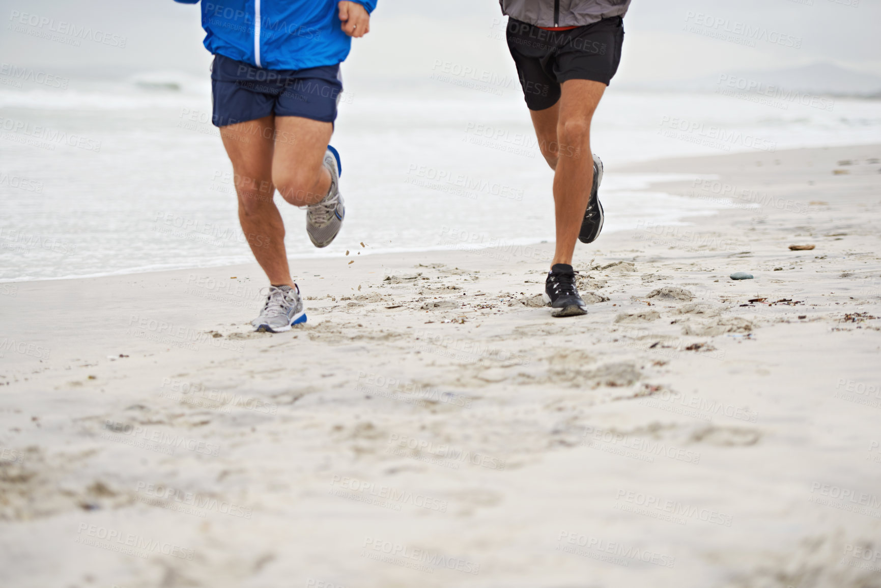 Buy stock photo Beach, legs or friends running for exercise, wellness or training outdoor in nature to workout for body health. Ocean, shoes or people together for fitness, cardio or jog for sport with energy at sea