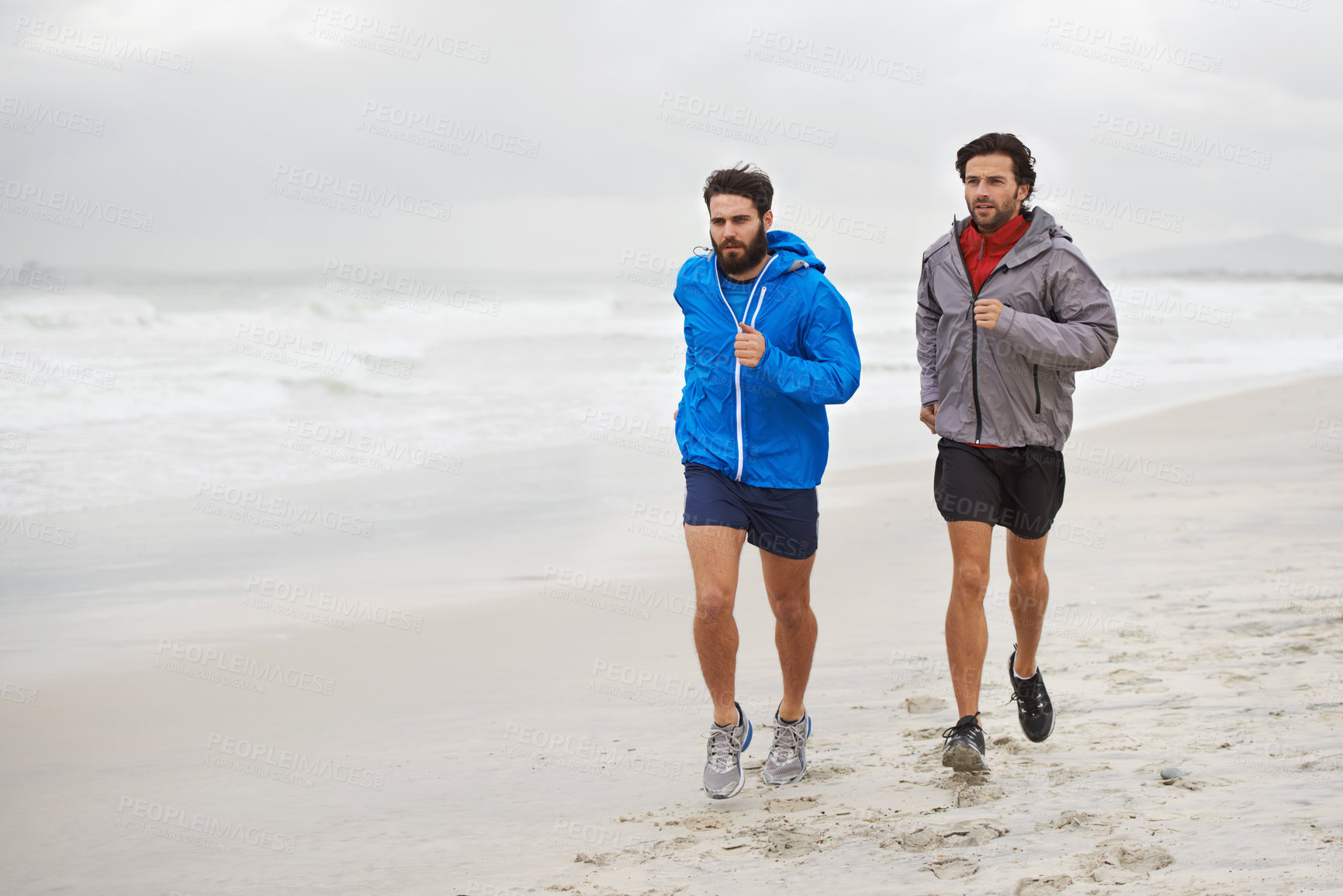 Buy stock photo Male athletes, running and workout on beach, sand and fitness for wellness and gym wear on coast travel. Men, jog and training for seaside, health and outdoor for sport and exercise together