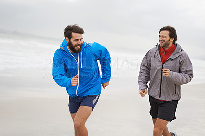 Buy stock photo Laugh, men and running on beach, sand and fitness for wellness and gym wear on ocean coast workout. Male athletes, jog and training for seaside, health and outdoor for sport and exercise together