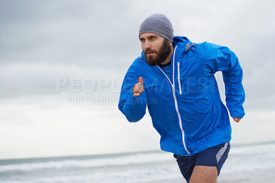 Buy stock photo Beach, man or running for exercise, wellness or training outdoor in nature to workout for body health. Ocean, athlete or person jog for fitness, cardio or sport with energy at sea in winter on mockup