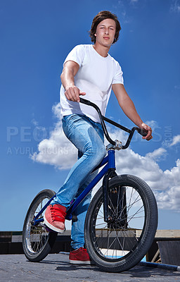 Buy stock photo Sky, bicycle and portrait of boy teenager riding for fitness, health or wellness in the road. Smile, sports and young man cycling on bike for transportation, adventure and adrenaline for practice.