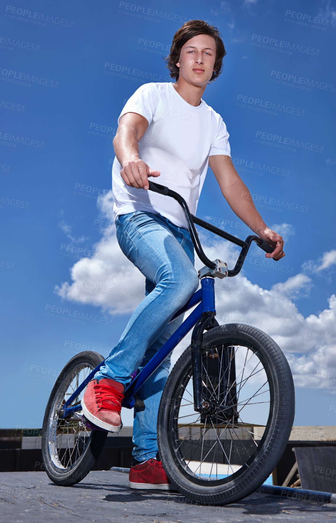 Buy stock photo Sky, bicycle and portrait of boy teenager riding for fitness, health or wellness in the road. Smile, sports and young man cycling on bike for transportation, adventure and adrenaline for practice.