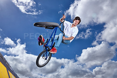 Buy stock photo Trick, jump and man with bike in sky at park, event or competition for sport with risk, energy or freedom. Mockup, space or person in air with fearless stunt on bicycle for fun adventure in summer