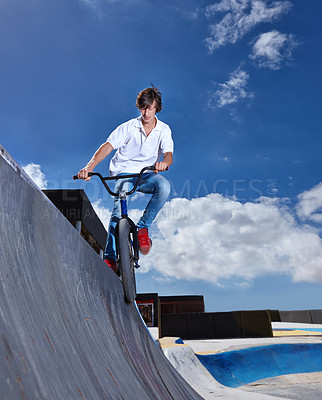 Buy stock photo Riding, bike and teen on ramp for sport performance, jump or training for event at skatepark with sky mockup. Bicycle, stunt or kid balance on edge of board in trick for cycling competition challenge