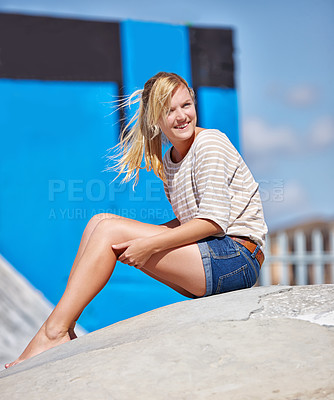 Buy stock photo Happy, girl and teenager relax outdoors with feet in skatepark in summer with casual fashion or style. Person, sitting and smile on ramp, waiting or watching skating outdoor event on holiday