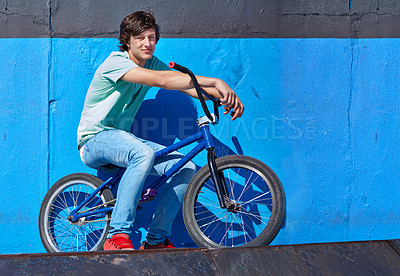 Buy stock photo Wall, bicycle and portrait of boy teenager riding for fitness, health or wellness in the road. Smile, sports and young man cycling on bike for transportation, adventure and adrenaline for practice.