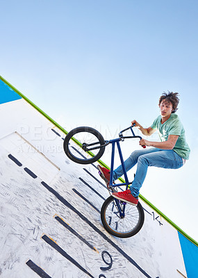 Buy stock photo Bike, trick and teenager in the air at skatepark with energy in performance for competition or event in summer. Bicycle, jump or stunt on wall with score, board and fearless freedom of cyclist in sky