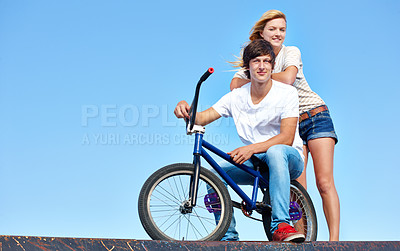 Buy stock photo Happy, friends and portrait of teenager at skatepark in summer on vacation or holiday with bicycle on sky. Cool, girl and boy on ramp with bike and smile for fun ride together in city mock up space