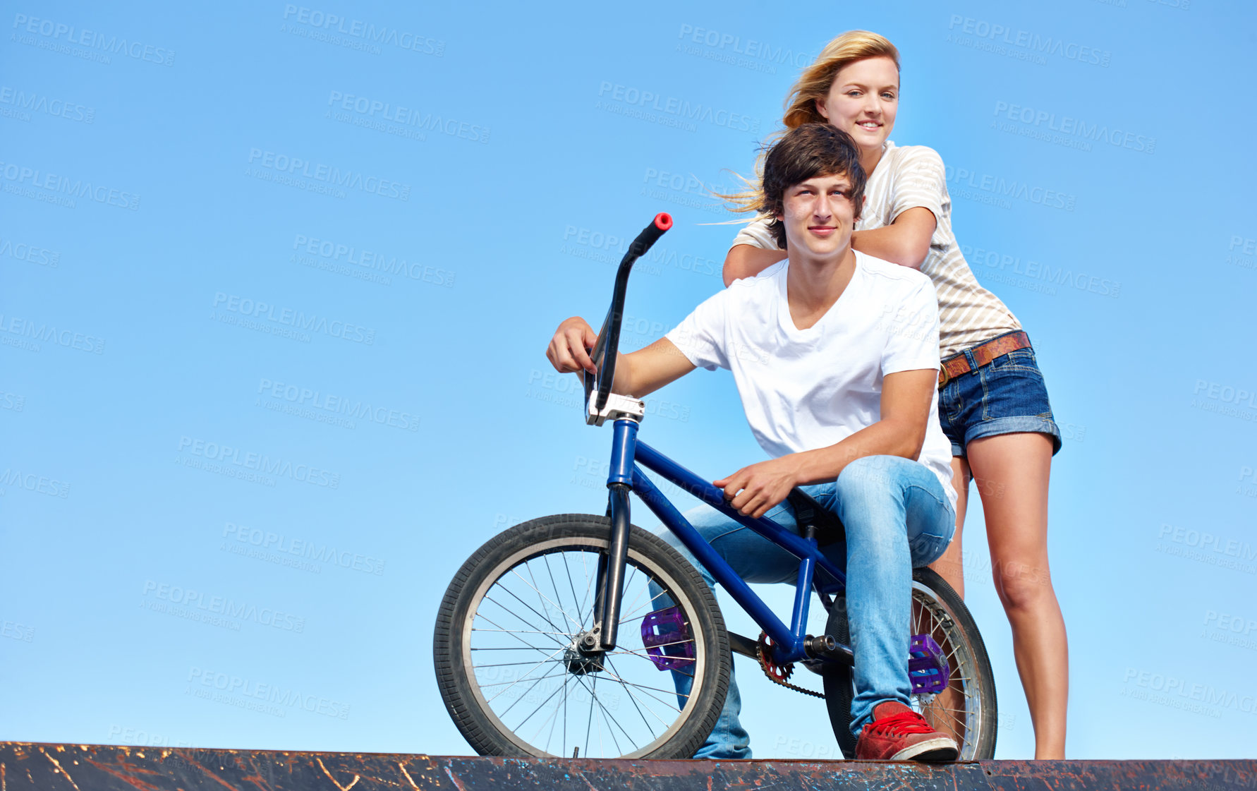 Buy stock photo Happy, friends and portrait of teenager at skatepark in summer on vacation or holiday with bicycle on sky. Cool, girl and boy on ramp with bike and smile for fun ride together in city mock up space