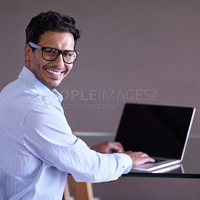 Buy stock photo Indian businessman, smile and portrait on laptop, technology and screen in office. Happiness, eyewear and computer for entrepreneur working on project, typing and keyboard for notes and research 