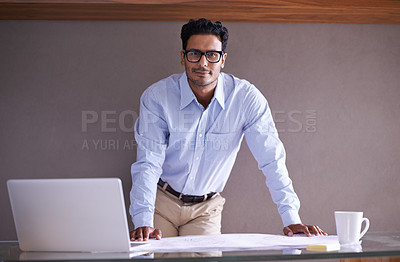 Buy stock photo Cropped shot of a handsome young businessman in his office