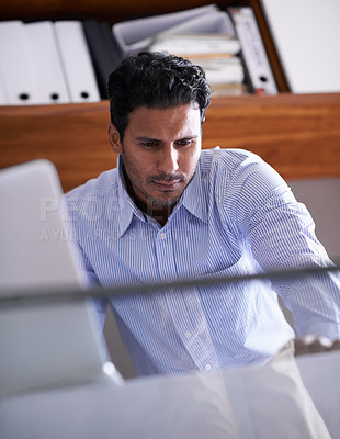 Buy stock photo Cropped shot of a handsome young businessman in his office