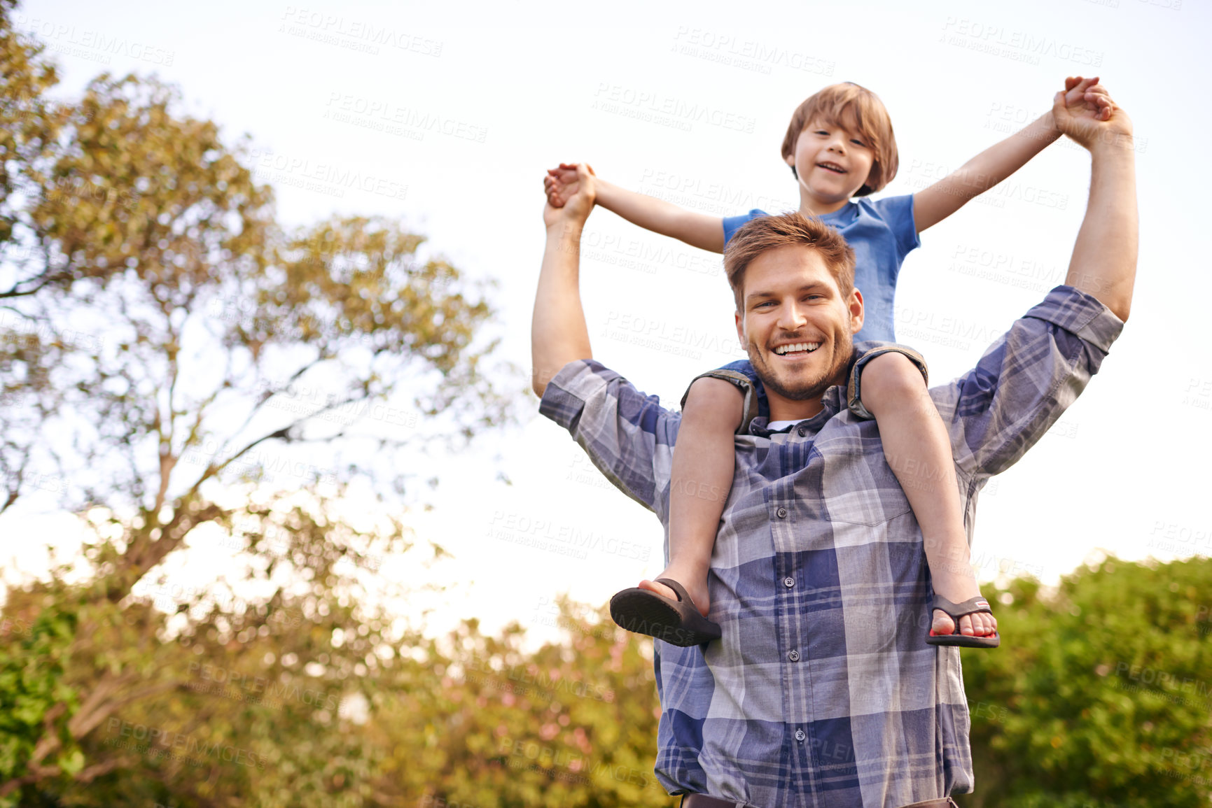 Buy stock photo Smile, nature and child on father shoulders in outdoor park or field for playing together. Happy, bonding and portrait of excited young dad carrying boy kid for fun in garden in Canada for summer.