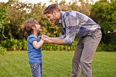 Buy stock photo Father, son and holding hands in park with smile, together and happiness in nature for quality time. Summer, parent and child outdoor to relax in sunshine, fun and play in garden with love as family