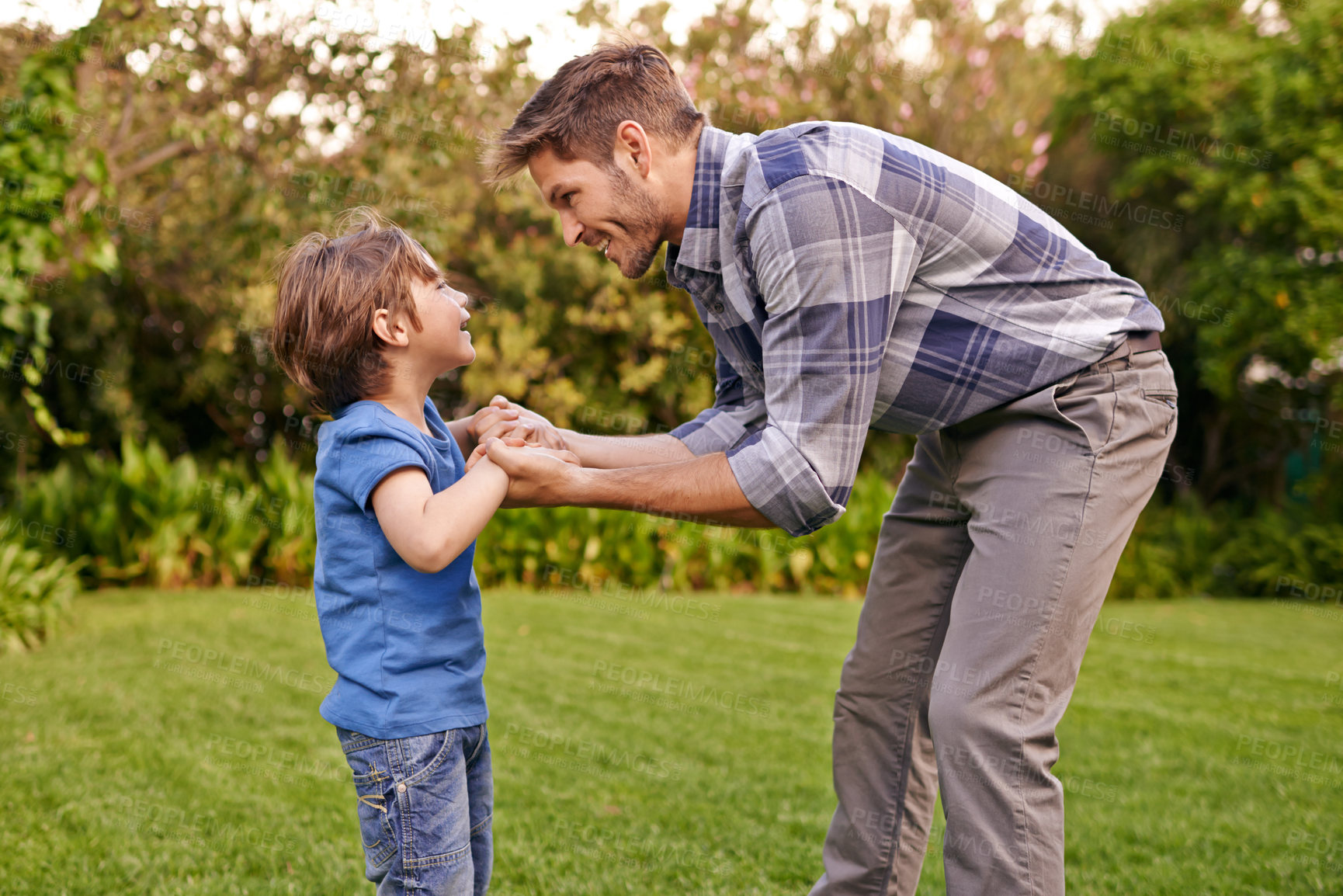 Buy stock photo Father, son and holding hands in park with smile, together and happiness in nature for quality time. Summer, parent and child outdoor to relax in sunshine, fun and play in garden with love as family