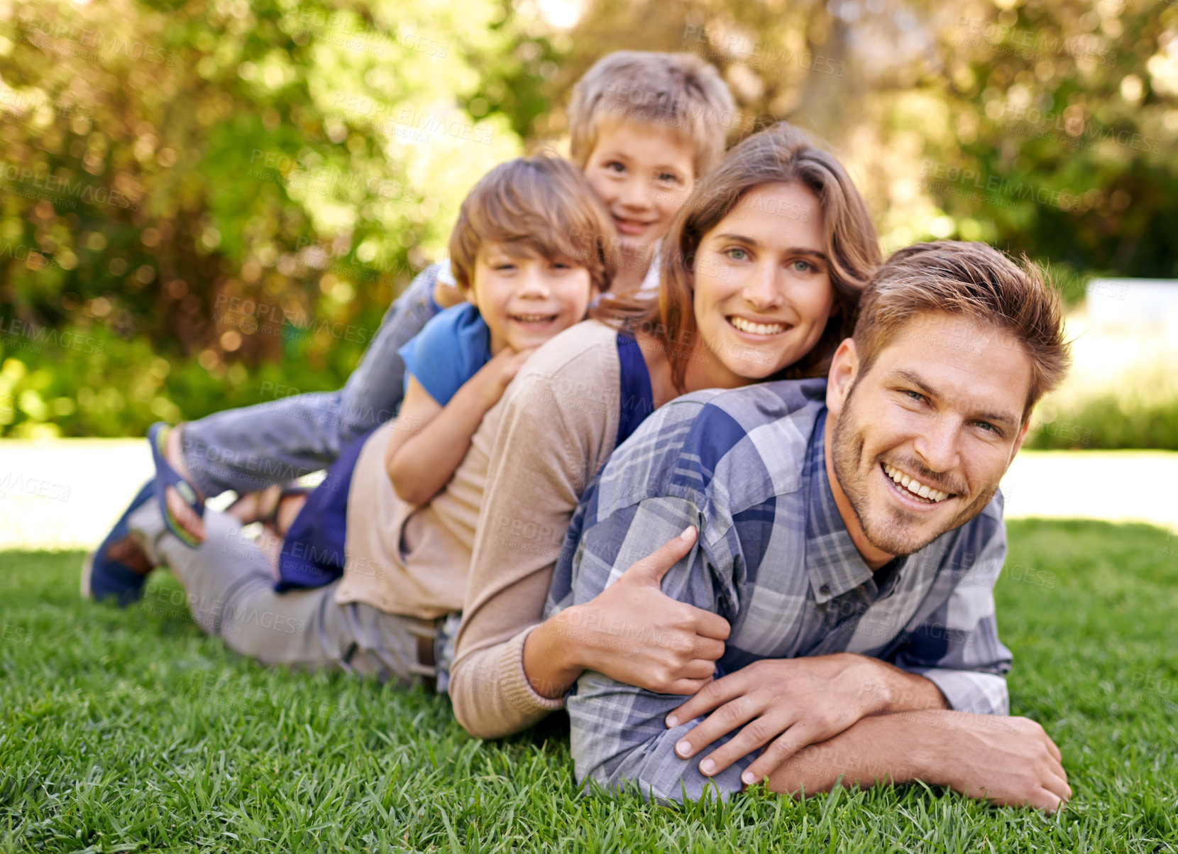 Buy stock photo Portrait of a loving family spending the day outdoors