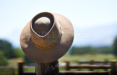 Buy stock photo Shot of a wide brimmed hat on a fence post