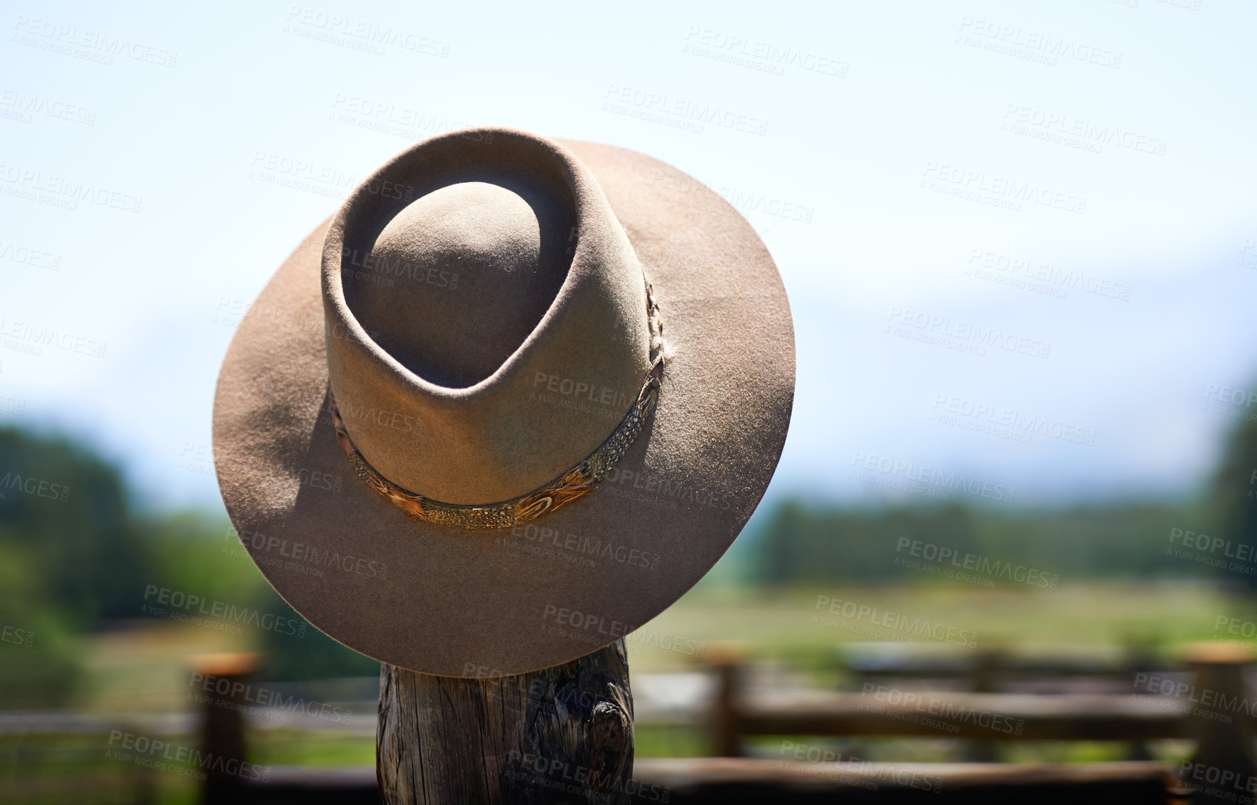 Buy stock photo Shot of a wide brimmed hat on a fence post