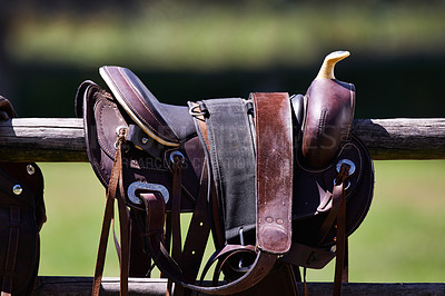 Buy stock photo Cropped shot of a saddle on a fence