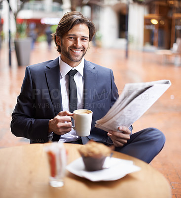 Buy stock photo A businessman having a coffee break while reading the news