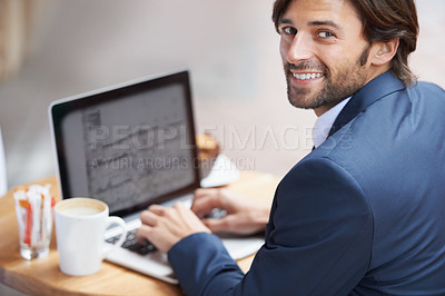 Buy stock photo A portrait of a happy businessman working on his laptop at a coffee shop