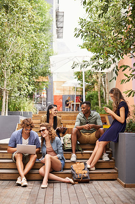 Buy stock photo Friends, happy and laptop or relax on break, campus and browse on social media for class update. Students, diversity or technology in college for online research and talking or phone for networking