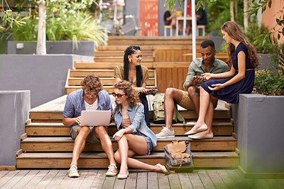 Buy stock photo Friends, happy and laptop or cellphone on break, campus and browse on social media for update. Students, diversity and technology at university for online research and talking to relax or networking