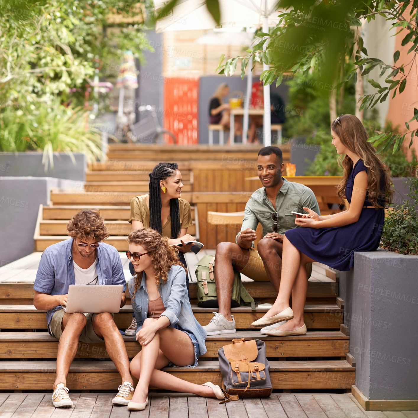 Buy stock photo Friends, happy and laptop or cellphone on break, campus and browse on social media for update. Students, diversity and technology at university for online research and talking to relax or networking