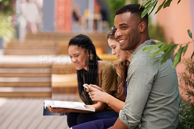 Buy stock photo Young man, friends and smile on campus or college for studying, relaxing and chilling together outside. Diverse people, group and happy with textbook, phone and internet for learning and bonding 