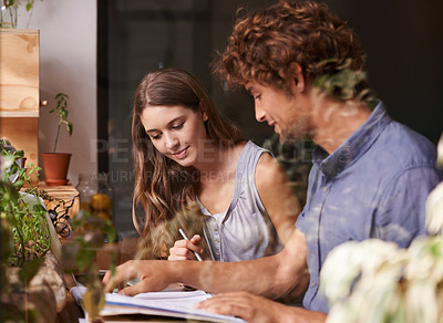 Buy stock photo Man, woman and research for writing, education and tutor in cafe in urban bistro. Couple of friends, college and article for university, class and reading for knowledge and study for date together