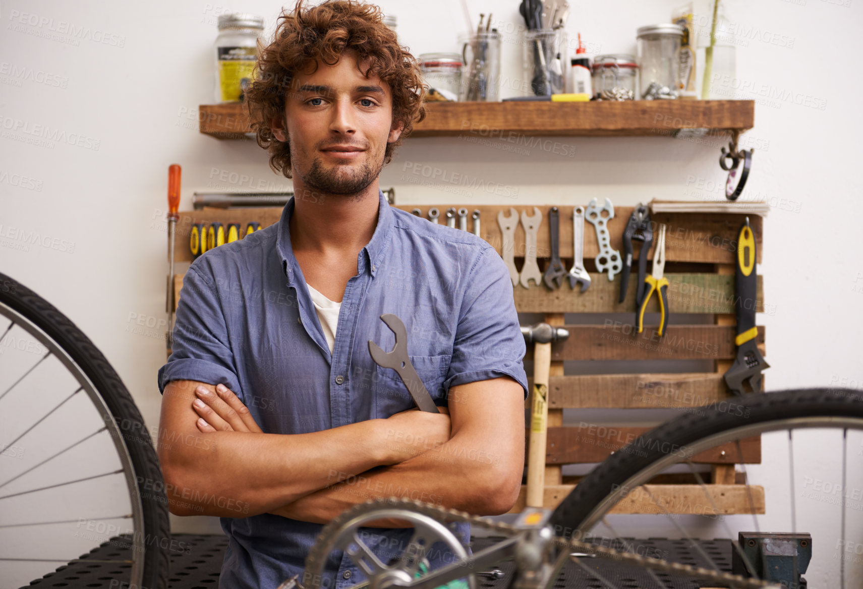 Buy stock photo Shot of a confident young bicycle repairman looking at the camera