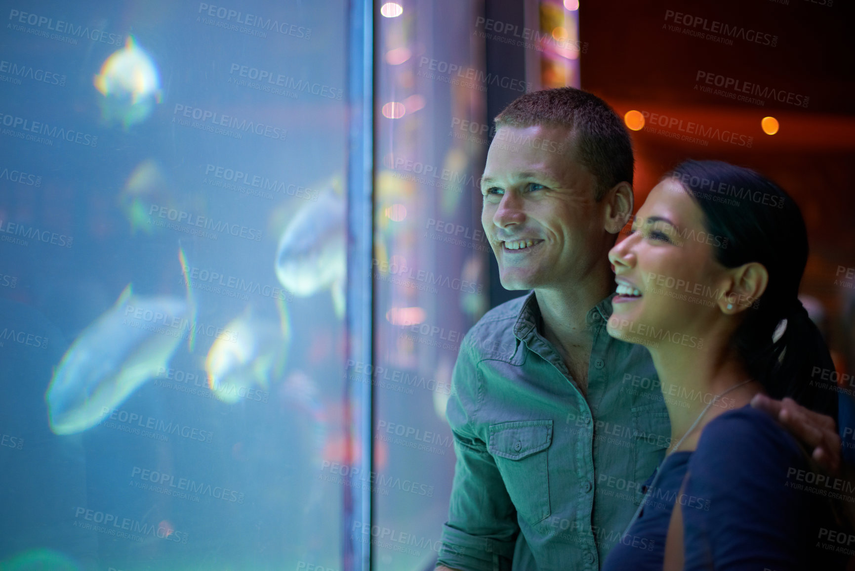 Buy stock photo Smile, aquarium and couple looking at fish on vacation, holiday or date together. Happiness, oceanarium and man and woman watching marine life, animals swimming underwater in fishtank and having fun