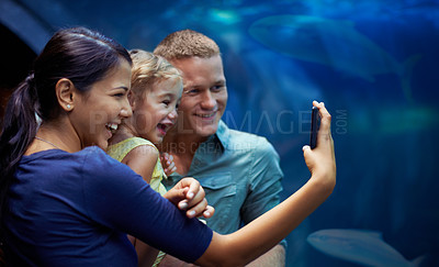 Buy stock photo Aquarium, happy and family selfie by fish on vacation, holiday and trip together. Photo, fishtank and father, mother and girl taking pictures for memory, social media or profile picture in oceanarium